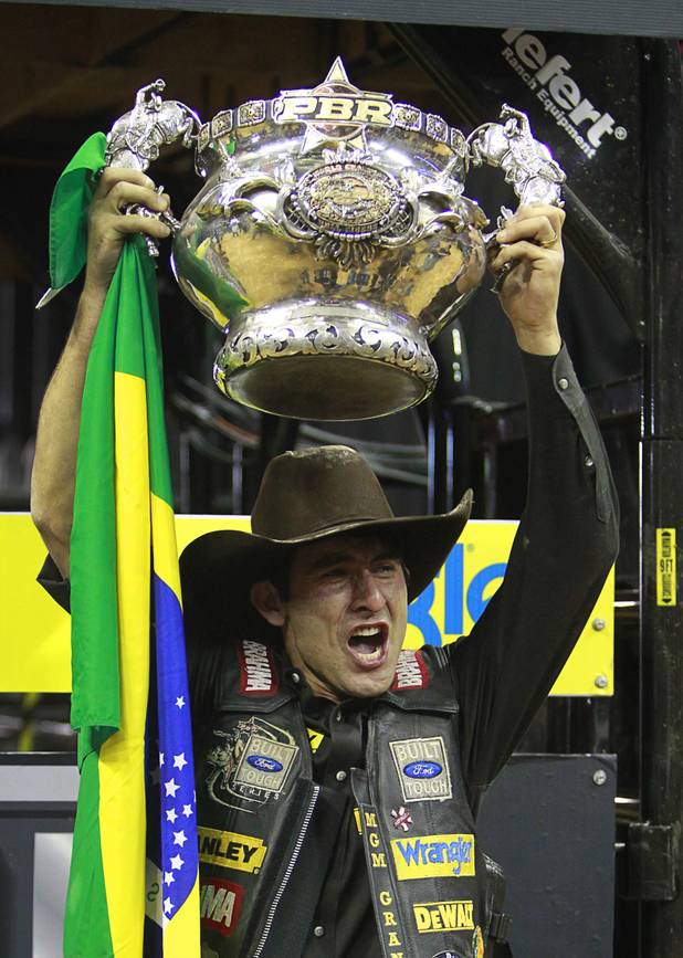Brazilian bull rider Silvano Alves celebrates with his trophy after winning the series championship during the Built Ford Tough Series Professional Bull Riders (PBR) World Finals at the Thomas & Mack Center Sunday, Oct. 28, 2012. Alves is the first rider to win back-to-back series titles in PBR.