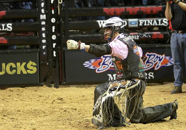 Ryan Dirteater of Hulbert, Okla. celebrates a successful ride during the Built Ford Tough Series Professional Bull Riders (PBR) World Finals at the Thomas & Mack Center Sunday, Oct. 28, 2012.