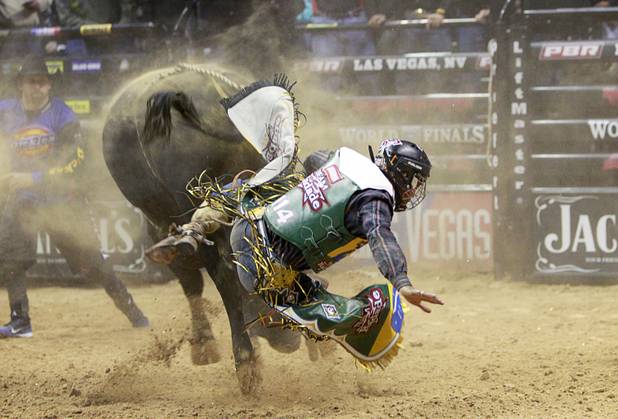 Davi Henrique De Lima Andrade is thrown from a bull during the Built Ford Tough Series Professional Bull Riders (PBR) World Finals at the Thomas & Mack Center Sunday, Oct. 28, 2012.