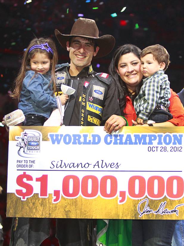 Brazilian bull rider Silvano Alves poses with his family after winning the series championship during the Built Ford Tough Series Professional Bull Riders (PBR) World Finals at the Thomas & Mack Center Sunday, Oct. 28, 2012. Pictured are daughter Hanyelle, 3, wife Evelin and son Eduardo,1. Alves is the first rider to win back-to-back series championships in PBR. Alves earned a $1 million bonus with the win.