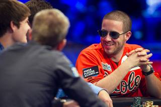 Greg Merson, right, talks with players during the World Series of Poker Main Event final table at the Rio on Monday, Oct. 29, 2012. 