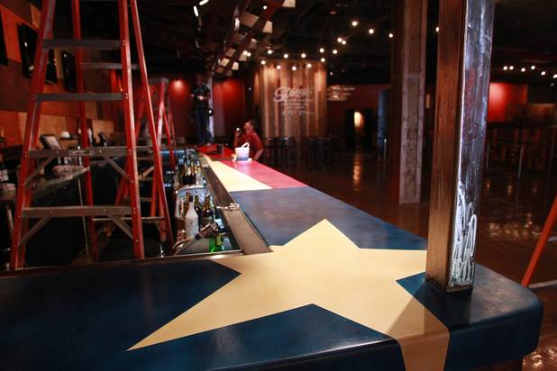 Workers finish work on a bar that features a Texas state flag design at Stoney's Rockin' Country's new location in Town Square Tuesday, Oct. 30, 2012.