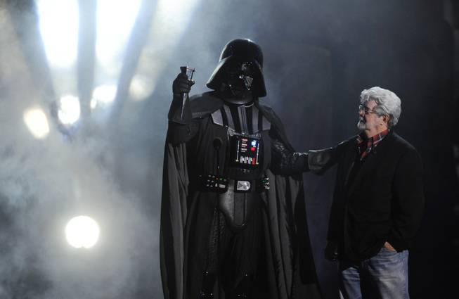 "Darth Vader" accepts the Ultimate Villain award from "Star Wars" creator George Lucas during the Scream Awards in Los Angeles, Oct. 15, 2011. 