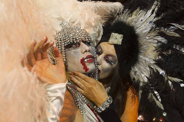 Angela Novobilski, left, and Dona Lopez ride in a Showgirls Mafia Entertainment entry during third annual Halloween Parade in downtown Las Vegas Wednesday, October 31, 2012.