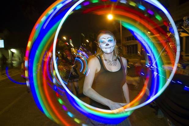 Flameology performer Becka McFarland spins a illuminated hula hoop during third annual Halloween Parade in downtown Las Vegas Wednesday, October 31, 2012.