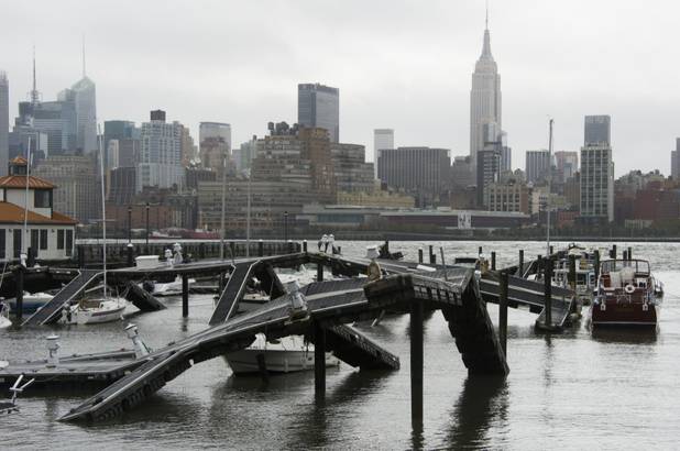 The twisted remains of a Hudson River marina are seen across from New York City as a result of superstorm Sandy on Tuesday, Oct. 30, 2012 in Hoboken, NJ. (AP Photo/Charles Sykes)