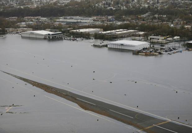 A runway at the Teterboro Airport is flooded in the wake of superstorm Sandy on Tuesday, Oct. 30, 2012, in New York. (AP Photo/Mike Groll)