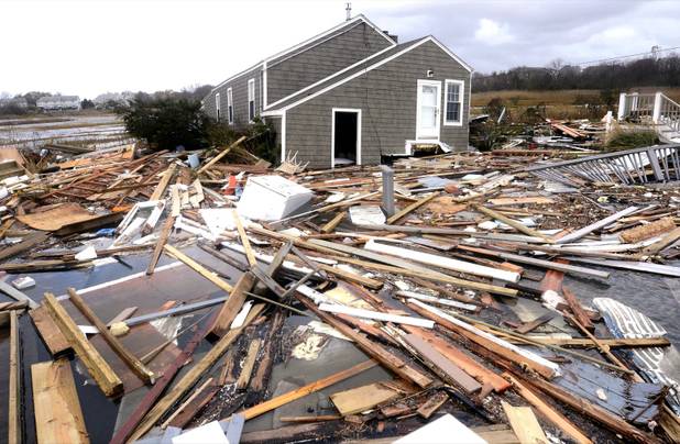 Debris floats around a house pushed off it's foundation in the aftermath of superstorm Sandy in East Haven, Conn., Tuesday, Oct. 30, 2012.  Sandy, the storm that made landfall Monday, caused multiple fatalities, halted mass transit and cut power to more than 6 million homes and businesses. (AP Photo/Jessica Hill)