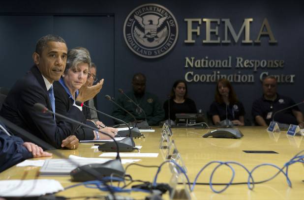 President Barack Obama, accompanied by Homeland Security Secretary Janet Napolitano, second from left, and others, speaks about superstorm Sandy during a visit to the Federal Emergency Management Agency (FEMA) Headquarters in Washington, Wednesday, Oct. 31, 2012. (AP Photo/Carolyn Kaster)