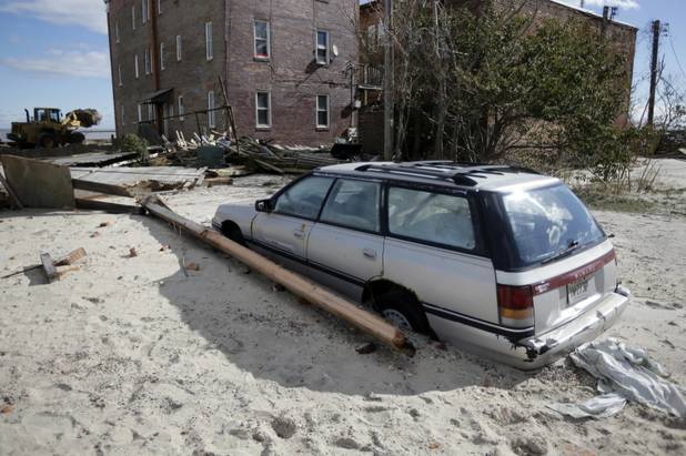 A damaged car is shown in the wake of superstorm Sandy, Wednesday, Oct. 31, 2012, in Atlantic City, N.J.  Sandy was being blamed for at least six deaths across the state plus power outages that at their peak Monday affected 2.7 million residential and commercial customers. (AP Photo/Matt Slocum)