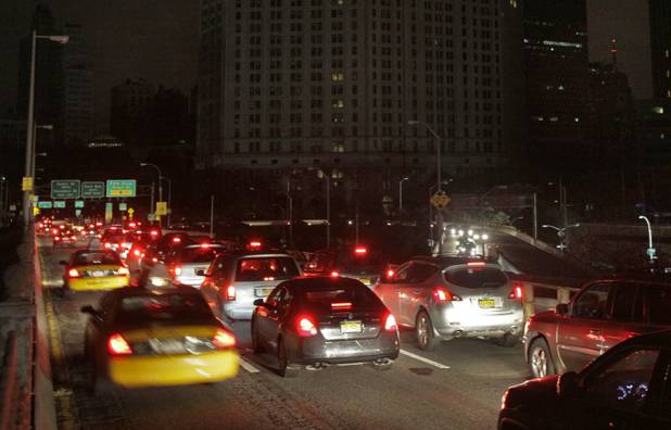Early morning commuters cross New York's Brooklyn Bridge, Wednesday, Oct. 31, 2012. Morning rush-hour traffic appeared thicker than on an ordinary day as people started to return to work in a New York without functioning subways. Cars were bumper-to-bumper on several major highways. (AP Photo/Richard Drew)