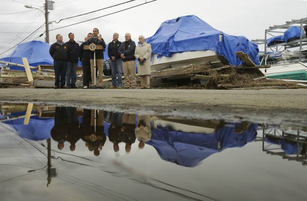 President Barack Obama, center, with New Jersey Gov. Chris Christie, Federal Emergency Management Agency administrator Craig Fugate, and other local and federal officials, speak about the relief efforts causes by the effect of superstorm Sandy, while standing in front of North Point Marina, Wednesday, Oct. 31, 2012, in Brigantine, N.J. (AP Photo/Pablo Martinez Monsivais)