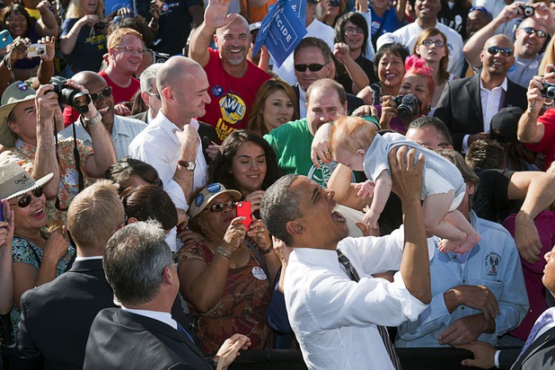 President Barack Obama holds up five-month-old Michael Mitchell Jr. during a campaign rally at the Cheyenne Sports Complex near the College of Southern Nevada in North Las Vegas Thursday, Nov. 1, 2012. 