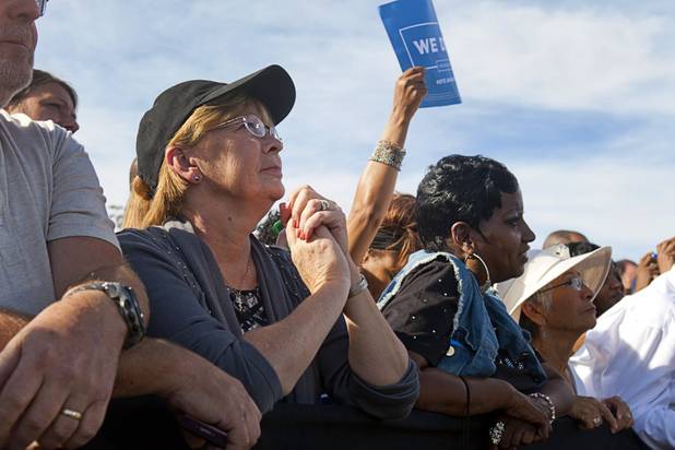A woman listens to President Barack Obama during at a campaign rally at the Cheyenne Sports Complex near the College of Southern Nevada in North Las Vegas Thursday, Nov. 1, 2012.