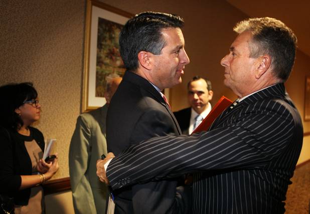 Governor Brian Sandoval greets Steve Schorr of Cox Communications before delivering the keynote address during the Governor's Conference on Small Business at the Orleans on Friday, November 2, 2012.
