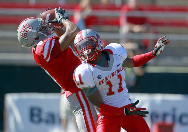 UNLV's Anthony Williams pulls down a pass over New Mexico's Destry Berry during the first half of their game at Sam Boyd Stadium on Saturday, Nov. 3, 2012.