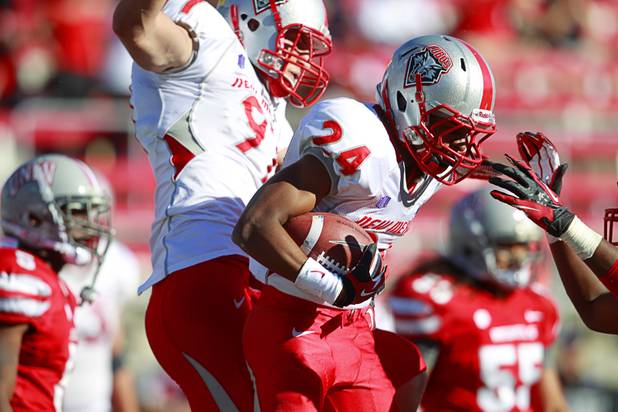 New Mexico's Carlos Wiggins, right, celebrates with Lucas Reed after New Mexico's only touchdown against UNLV at Sam Boyd Stadium Saturday, Nov. 3, 2012.
