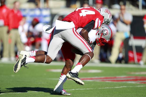 UNLV's Kenny Keys takes down New Mexico's Lamaar Thomas during UNLV's game against New Mexico at Sam Boyd Stadium Saturday, Nov. 3, 2012.