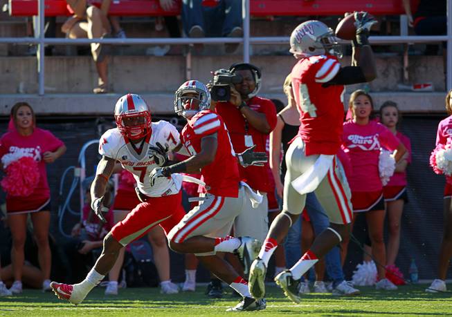 UNLV's Kenny Keys, right, picks off a pass intended for New Mexico's Lamaar Thomas during UNLV's game against New Mexico at Sam Boyd Stadium Saturday, Nov. 3, 2012.