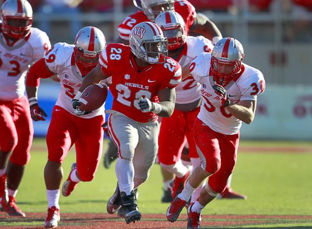 UNLV's Bradley Randle, center, outruns a host of New Mexico defenders for a touchdown at Sam Boyd Stadium Saturday, Nov. 3, 2012.