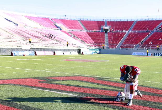 UNLV's David Greene pauses for a prayer before leaving the field at Sam Boyd Stadium Saturday, Nov. 3, 2012. UNLV beat New Mexico 35-7.