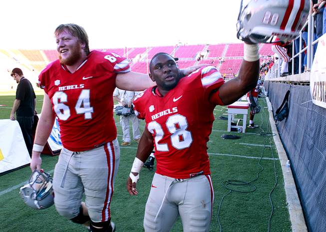 UNLV players Doug Zismann and Bradley Randle leave the field after UNLV's game against New Mexico at Sam Boyd Stadium on Saturday, Nov. 3, 2012. UNLV beat New Mexico 35-7.