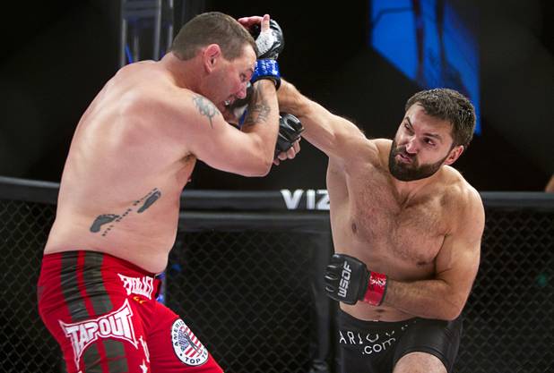 Heavyweight Devin Cole of Medford, Ore. takes a punch from Andrei Arlovski of Belarus during the World Series of Fighting debut at the PH Live theater at Planet Hollywood Saturday, Nov. 3, 2012. The event was broadcast live on the NBC Sports Network.