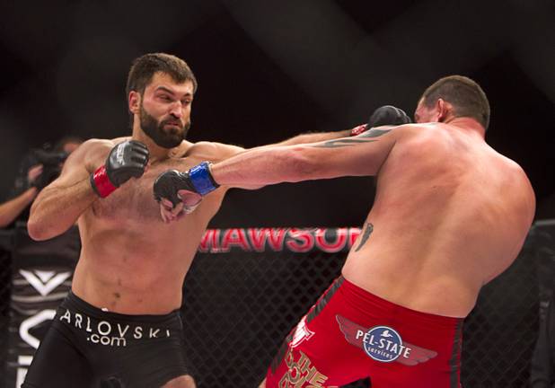 Heavyweight Andrei Arlovski of Belarus connects with a left on Devin Cole of Medford, Ore. during the World Series of Fighting debut at the PH Live theater at Planet Hollywood Saturday, Nov. 3, 2012. Arlovski followed with a right that sent Cole to the mat. The event was broadcast live on the NBC Sports Network.