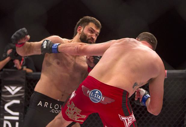 Heavyweight Andrei Arlovski of Belarus prepares to connect with a right that sends Devin Cole of Medford, Ore. to the mat during the World Series of Fighting debut at the Hollywood Live! theater at Planet Hollywood Saturday, Nov. 3, 2012. The event was broadcast live on the NBC Sports Network.