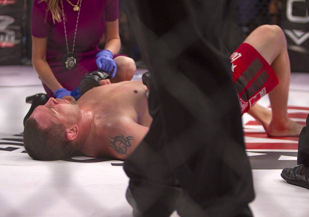 Heavyweight Devin Cole of Medford, Ore. lies on the mat after losing to Andrei Arlovski of Belarus by TKO during the World Series of Fighting debut at the PH Live theater at Planet Hollywood Saturday, Nov. 3, 2012. The event was broadcast live on the NBC Sports Network.