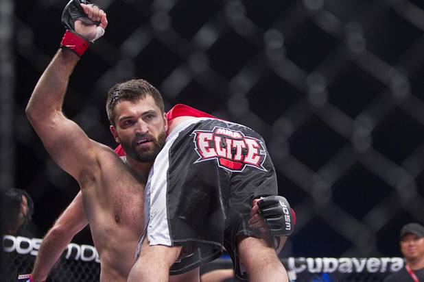 Heavyweight Andrei Arlovski of Belarus celebrates by carrying a member of his corner around the cage after beating Devin Cole of Medford, Ore. by TKO during the World Series of Fighting debut at the PH Live theater at Planet Hollywood Saturday, Nov. 3, 2012. The event was broadcast live on the NBC Sports Network.