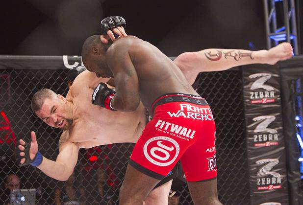 DJ Linderman, left, of Yreka, Calif. struggles to keep his balance against Anthony Johnson of Boca Raton, Fla. during the World Series of Fighting debut in the PH Live theater at Planet Hollywood Saturday, Nov. 3, 2012. The event was broadcast live on the NBC Sports Network.
