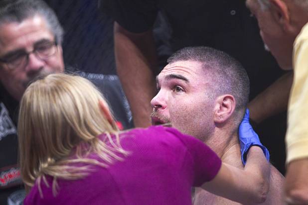DJ Linderman of Yreka, Calif. is check by a physician after being knocked out by Anthony Johnson of Boca Raton, Fla. during the World Series of Fighting debut in the PH Live theater at Planet Hollywood Saturday, Nov. 3, 2012. The event was broadcast live on the NBC Sports Network.