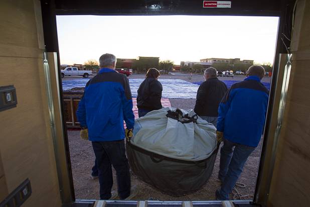 Members of the Split Paint Hot Air Balloon Team carry a balloon from a trailer during the Friends of Metro Search and Rescue Las Vegas Balloon Festival and carnival at the Southern Hills Hospital campus on West Sunset Road Sunday, Nov. 4, 2012.  Festival proceeds from the balloon rides will benefit the nonprofit organization that helps support members of the Las Vegas Police Department Metro Search and Rescue section, many of whom are volunteers.