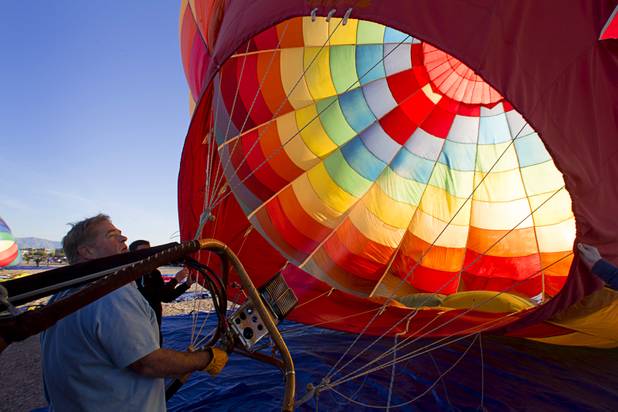 Pilot Dave Lynch, left, of Temecula, Calif. uses propane burners to heat up the air in his ballon during the Friends of Metro Search and Rescue Las Vegas Balloon Festival and carnival at the Southern Hills Hospital campus on West Sunset Road Sunday, Nov. 4, 2012.  Festival proceeds from the balloon rides will benefit the nonprofit organization that helps support members of the Las Vegas Police Department Metro Search and Rescue section, many of whom are volunteers.