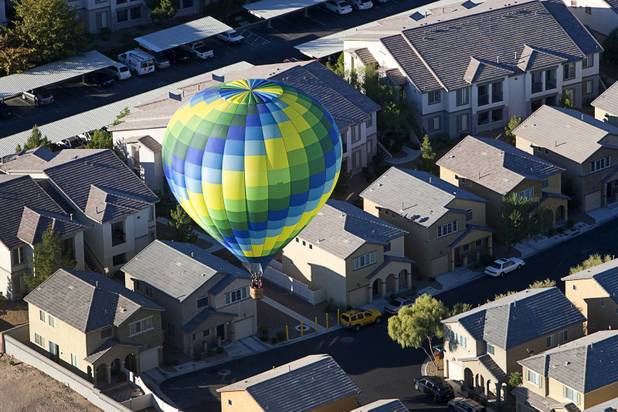 A hot air balloon floats over a neighborhood in the southwest part of the Las Vegas Valley during the Friends of Metro Search and Rescue Las Vegas Balloon Festival and carnival at the Southern Hills Hospital campus on West Sunset Road Sunday, Nov. 4, 2012.  Festival proceeds from the balloon rides will benefit the nonprofit organization that helps support members of the Las Vegas Police Department Metro Search and Rescue section, many of whom are volunteers.
