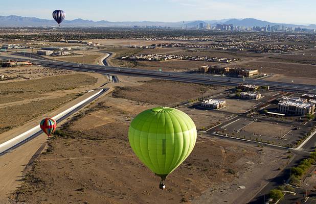 Hot air balloons float over the southwest part of the Las Vegas Valley during the Friends of Metro Search and Rescue Las Vegas Balloon Festival and carnival at the Southern Hills Hospital campus on West Sunset Road Sunday, Nov. 4, 2012.  Festival proceeds from the balloon rides will benefit the nonprofit organization that helps support members of the Las Vegas Police Department Metro Search and Rescue section, many of whom are volunteers.