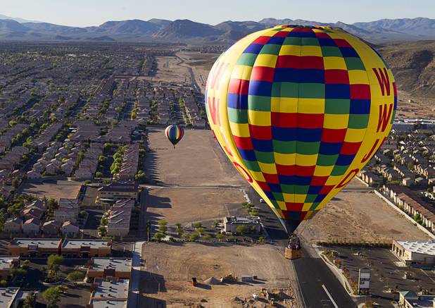 Hot air balloons float over neighborhoods in the southwest part of the Las Vegas Valley during the Friends of Metro Search and Rescue Las Vegas Balloon Festival and carnival at the Southern Hills Hospital campus on West Sunset Road Sunday, Nov. 4, 2012.  Festival proceeds from the balloon rides will benefit the nonprofit organization that helps support members of the Las Vegas Police Department Metro Search and Rescue section, many of whom are volunteers.