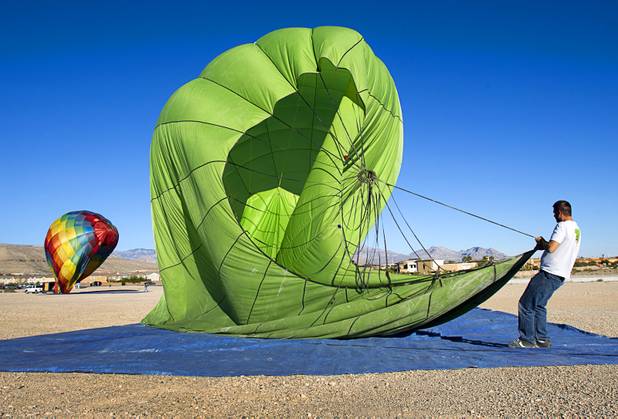 Matt Bowman, a Las Vegas Balloon Rides crew member, guides a balloon onto a tarp after a landing during the Friends of Metro Search and Rescue Las Vegas Balloon Festival and carnival at the Southern Hills Hospital campus on West Sunset Road Sunday, Nov. 4, 2012.  Festival proceeds from the balloon rides will benefit the nonprofit organization that helps support members of the Las Vegas Police Department Metro Search and Rescue section, many of whom are volunteers.