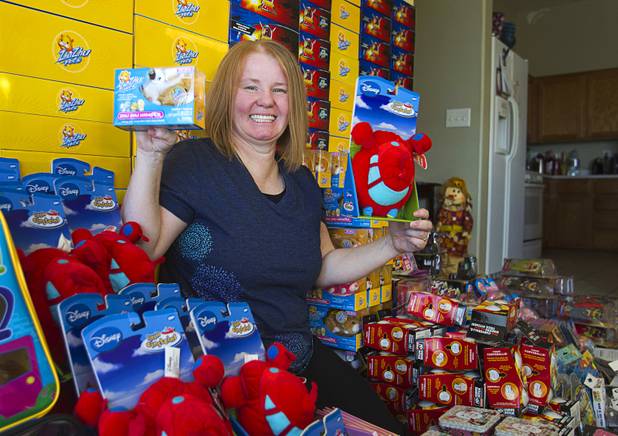 Susan England poses with toys at her home Sunday, Nov. 4, 2012. England made a New Year's resolution to collect 100 toys for $100 to donate to the Toys For Tots charity. Then, after she reached the goal, she just kept on going she said.