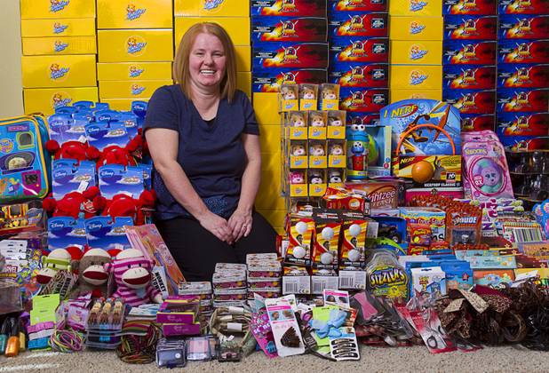 Susan England poses with toys at her home Sunday, Nov. 4, 2012. England made a New Year's resolution to collect 100 toys for $100 to donate to the Toys For Tots charity. Then, after she reached the goal, she just kept on going she said.