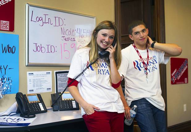 McKenzie Beckstead, 18, and Tommy Bonetti, 16, volunteers for the Mitt Romney for President campaign, are shown in a Henderson field office Monday, Nov. 5, 2012.