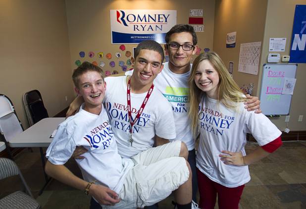 Volunteers for the Mitt Romney for President campaign, from left, Bond Headlee, 14, Tommy Bonetti, 16, Dorian Achaval, 17, and McKenzie Beckstead, 18, pose in a Henderson field office Monday, Nov. 5, 2012.