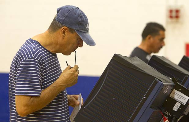 A voter (who declined to be identified) studies a ballot  on election day at the Fremont Middle School gym Tuesday, November 6, 2012.