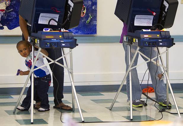 Antonio Reives, 2, waits for his mother to finish voting on election day at Paradise Elementary School Tuesday, November 6, 2012.