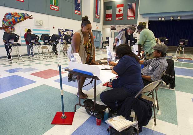 Jenise Geiger checks in with election workers on election day at Paradise Elementary School Tuesday, November 6, 2012.