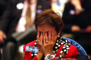 Dorothy Abate of Las Vegas puts her head in the hands after hearing the election called for Barack Obama during a GOP election night watch party at the Venetian in Las Vegas on Tuesday, November 6, 2012.