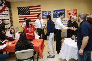 Republican presidential candidate, former Massachusetts Gov. Mitt Romney and his vice presidential running mate, Rep. Paul Ryan, R-Wis., greet campaign workers at a call center in Richmond Heights, Ohio, on Election Day, Tuesday, Nov. 6, 2012. (AP Photo/Charles Dharapak)