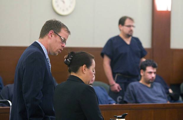 Chief Deputy Attorney General Thom Gover, left and Parole and Probation Officer Adriana Lindquist , address the court as David Schubert, the former Clark County prosecutor who was arrested for buying cocaine and then fled to Mexico, stands in the background at the Regional Justice Center Wednesday, November 7, 2012.