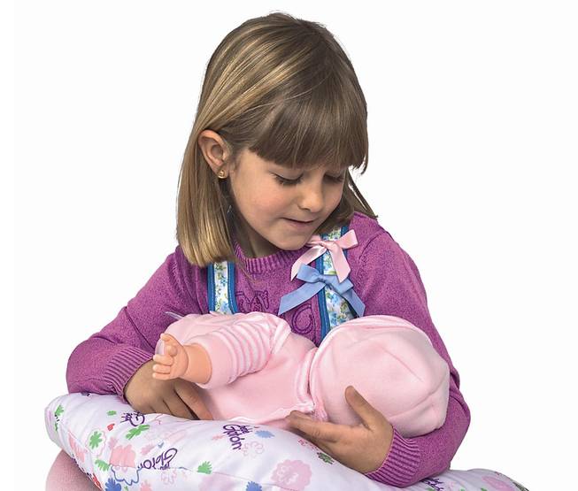 This product image released by Berjuan Toys shows a girl playing with the Breast Milk Baby doll. The breastfeeding doll, whose suckling sounds are prompted by sensors sewn into a halter top, has caught some flak after hitting the U.S. market.